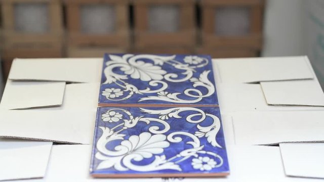 Blue ceramic tiles with white arabesque desing in alternate focus