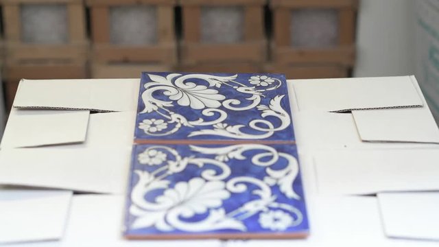 Blue ceramic tiles with white arabesque desing in alternate focus