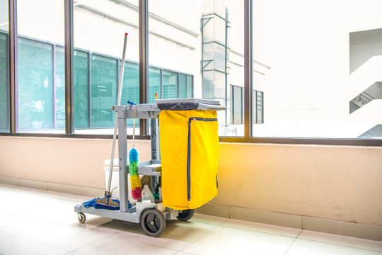 Cleaning tools cart wait for cleaning,Yellow mop bucket and set of cleaning equipment in the airport
