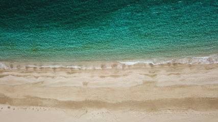 Aerial drone bird's eye view photo of iconic beach with turquoise clear waters located in Greek island