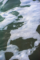 Sea water surface with wave and foam