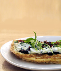 French omelet with pastrami, cheese mousse, cucumber and arugula