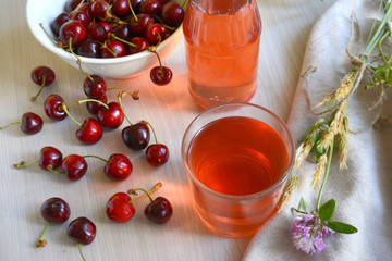 Cherry juice and berries on the table. Summer still life