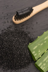 Toothbrush with black charcoal toothpaste with aloe vera