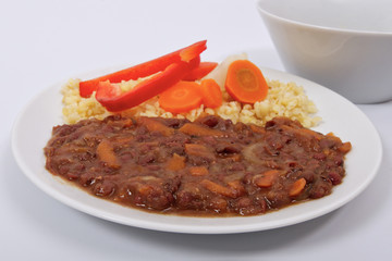 Azuki with vegetables on steam and bulgur on a white