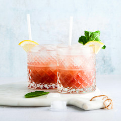 pink non-alcoholic mocktail made from grapes with lemon and mint and shaker . summer refreshing...