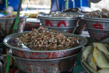Big barrels with different freshwater prawns and shrimps on a local market in central america.