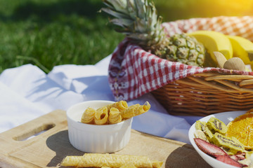 Picnic at the park on the grass: healthy food and accessories, top view