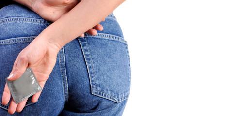 Woman is holding a condom in her hand