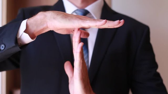 Businessman showing timeout gesture