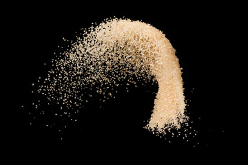Brown sugar splash isolated on black background  ,throwing freeze stop motion element food and drink object design