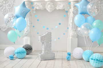 Obraz premium One year birthday decorations. A lot of balloons blue and white colors. Blue stars. Big Balloons. Cake for holiday party. 