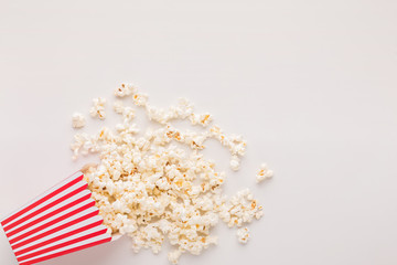 Bucket of popcorn on white background - obrazy, fototapety, plakaty