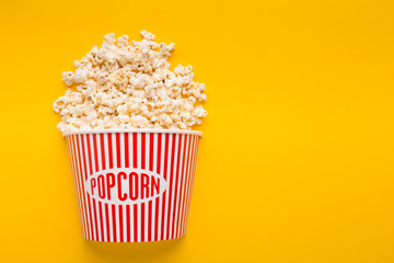 Bucket of popcorn on yellow background