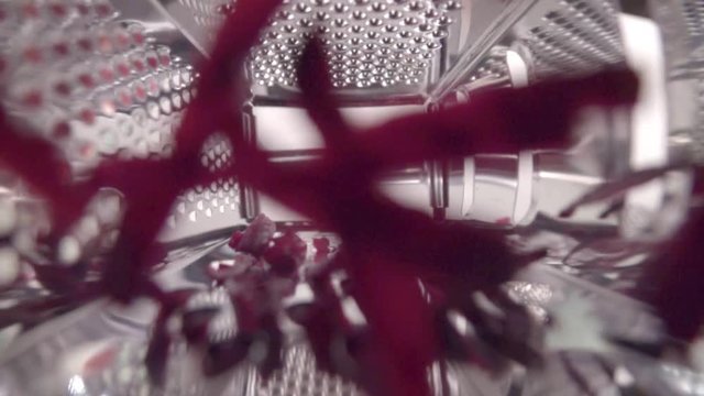 Beetroot passing through grater shot of a piece of beetroot . Close up. Slow motion