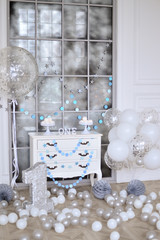 One year birthday decorations ideas. Decoration for holiday party. A lot of balloons Silver and white colors. Cake for holiday party. 