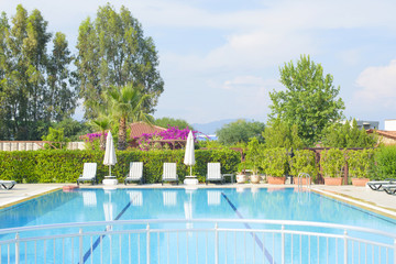 recreation area with swimming pool and sun beds
