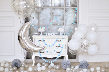 One year birthday decorations ideas. Decoration for holiday party. A lot of balloons Silver and white colors. Cake for holiday party. 