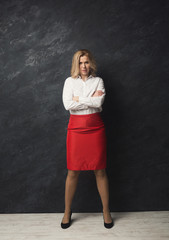 Smiling businesswoman portrait at gray studio background