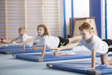 Kids exercising balancing yoga pose © Photographee.eu