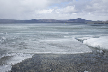 Spring lake with melting ice