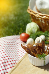 Picnic at the park on the grass: healthy food and accessories, top view