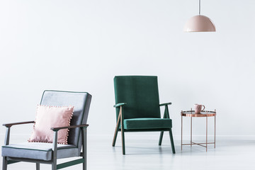 Old-fashioned armchairs in white interior