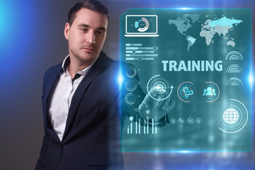 Business, Technology, Internet and network concept. Young businessman working on a virtual screen of the future and sees the inscription: Training