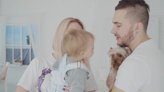 Little lovely girl kissing the dog. Happy family. Slow motion