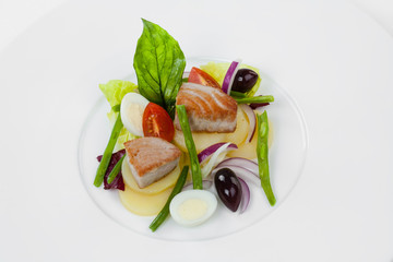 Salad Nicoise with tuna on a white plate