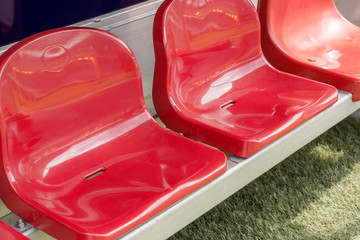 Naklejka premium Detail of red Reserve chair and staff coach bench in sport stadium