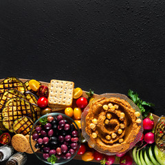 Obraz na płótnie Canvas Vegan snack board. Flat-lay of Various Vegetarian dishes hummus