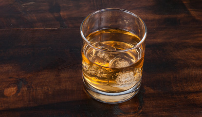 whisky on the rock on wood and wood background