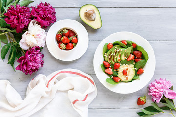 breakfast vegan salad with avocado, strawberries, pine nuts