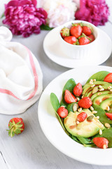 Obraz na płótnie Canvas breakfast vegan salad with avocado, strawberries, pine nuts