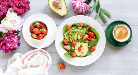 breakfast vegan salad with avocado, strawberries, pine nuts