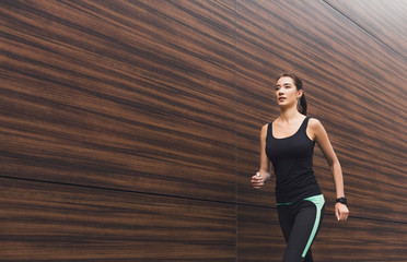 Young woman running in city copy space