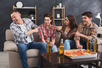 Young friends playing funny game who I am