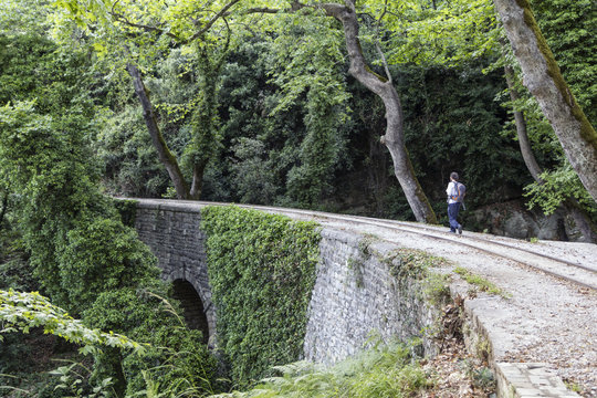 Greece, Pilion, Milies, man walking along rails of Narrow Gauge Railway