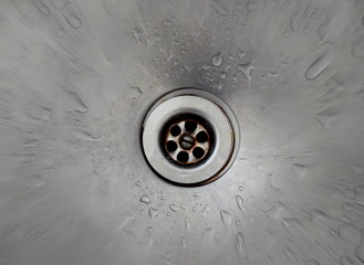 limpid drops of water in a metal kitchen sink