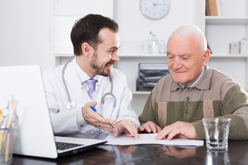 Naklejka na ściany i meble Old man visits doctor
