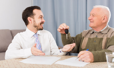 Man selling car at home