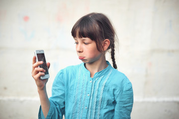 Broken glass screen smartphone in hand of upset girl, white background.