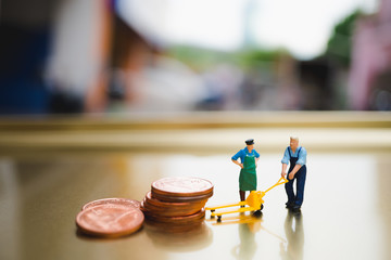 Miniature people, man moving stack coins, using for logistic, business and finance concept