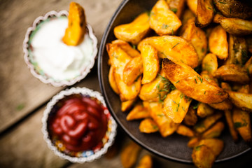 Baked potato fries on wooden table
