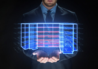 architecture, technology and construction concept - close up of businessman with virtual building blueprint projection
