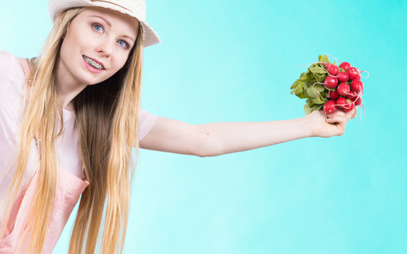 Happy woman holding radish