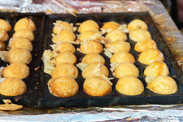 Cooking Takoyaki on hot pan Famous food Osaka Japan. Street food