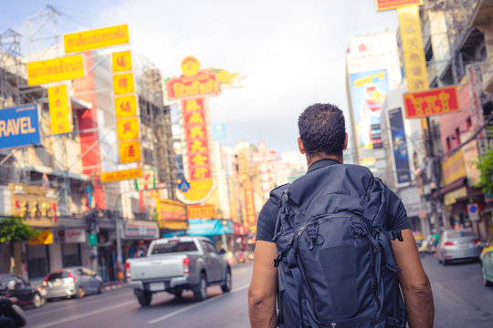 men backpacker looking at the famous place of Yaowarat road in Chinatown Bangkok during day, Thailand , Southeast asia .