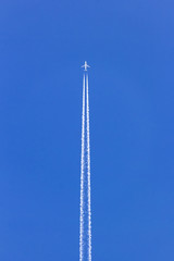 white vapor trail from the jet plane on blue sky